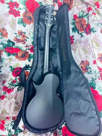 Matte black acoustic electric guitar with soft gig bag - used