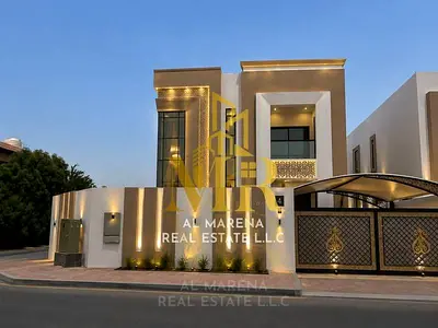 A luxurious villa in a prime location in Al Muwaihat 3, Ajman, with 5 master bedrooms, a majlis and living room, an American-style kitchen, and a larg