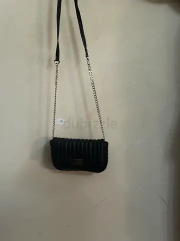 Small black quilted shoulder bag with chain strap