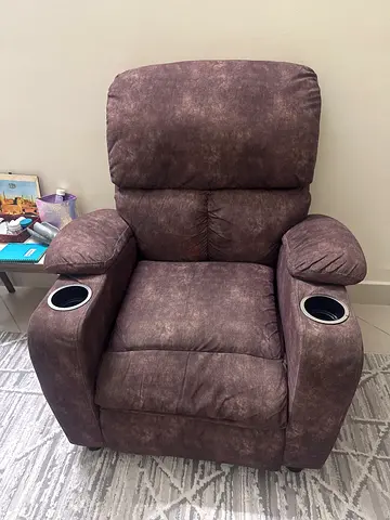 Comfortable brown single recliner armchair with cup holders
