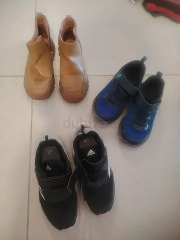 Three pairs of kids shoes (Adidas black, blue sneakers and brown boots) - used 10 AED for all