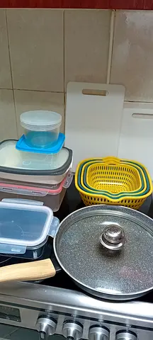 Used kitchen cookware set: pots, lids, storage containers and accessories