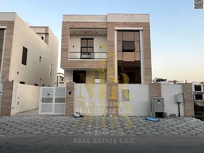 Luxury villa for sale in Al Yasmeen, two floors plus a roof terrace, 7 master bedrooms, electricity, water, and air conditioning included. Freehold ow