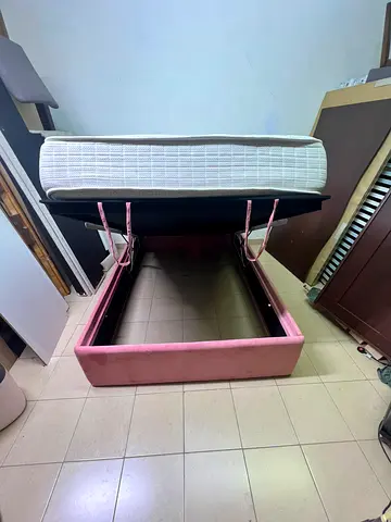 Queen storage bed with lift-up mattress - pink upholstered frame