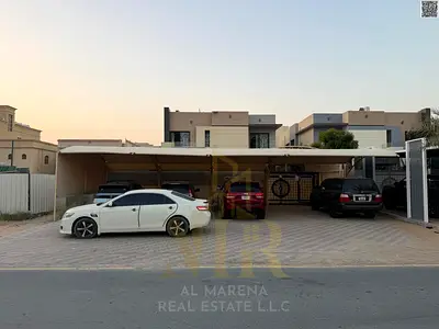 Villa in Al Muwaihat 1, residential/commercial, near Sheikh Ammar Street and Salem Mall. Price includes electricity, water, and air conditioning. The