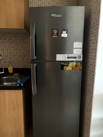 Used stainless steel double-door refrigerator with top freezer
