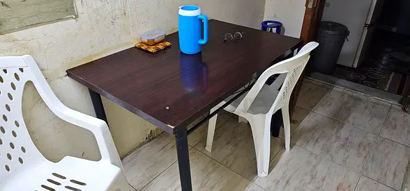 Simple wooden dining table with metal legs - good condition