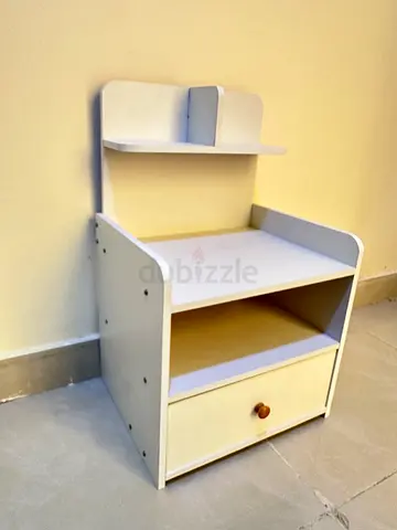 Small white bedside table with drawer and shelf, used but still ok. 50 AED is last price