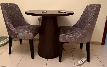 Small round wooden dining table with two upholstered chairs - set of 3