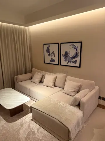 Beige L-shaped Fabric Sofa with Ottoman - Good Condition