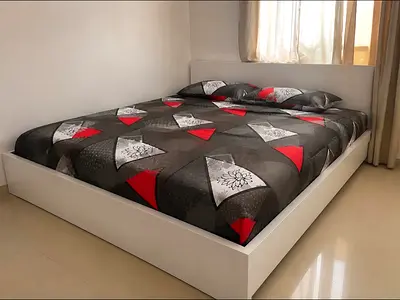 Modern White Bed Frame with Geometric Bedding