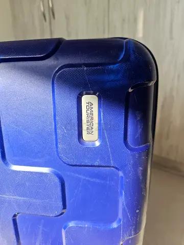 American tourister Blue hard-shell carry-on suitcase with telescopic handle