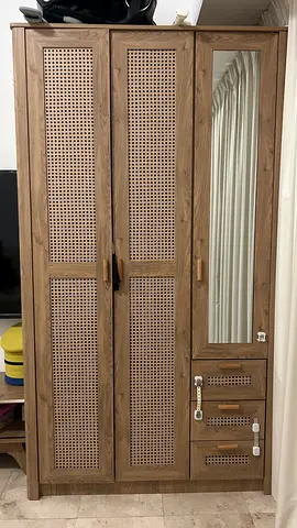 Three-door wooden wardrobe with mirror and rattan panels