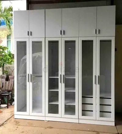 Large white multi-door wardrobe with glass panels and overhead storage