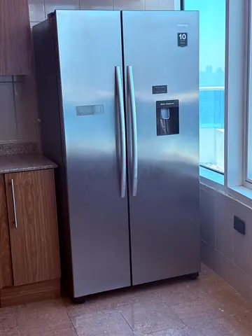 Large double-door stainless steel refrigerator with water dispenser - good condition
