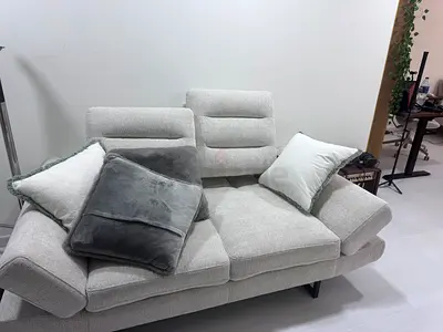Light grey 3-seater fabric sofa bed with adjustable armrests and cushions