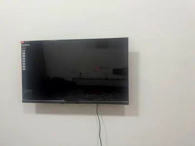 32-inch LED TV mounted on wall - good working condition