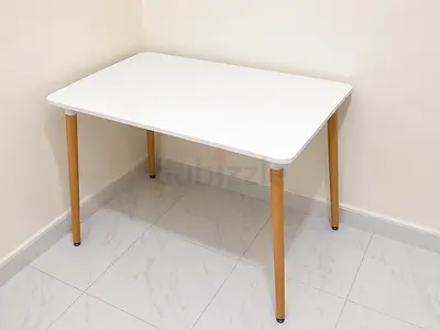 White Scandinavian-style dining table with wooden legs - good condition