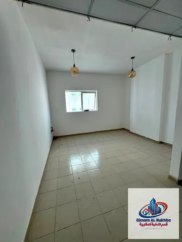 **One-Bedroom Apartment in Al Qulayaah, Sharjah** featuring **central air conditioning and central gas**, a **modern, well-organized kitchen**, a **lu