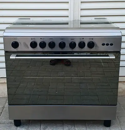 it is 5 burner Bompani brand, gas cooker, its condition is working perfectly. size 90x60cm