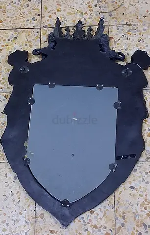 Antique-style decorative wall mirror with crest frame