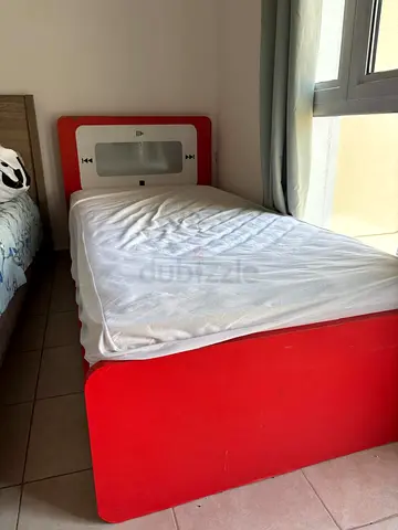 Single red kids bed with mattress — playful cassette design