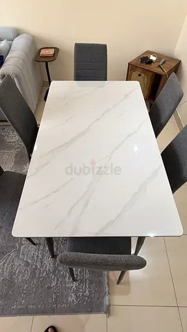 6-seater marble-top dining table with upholstered chairs
