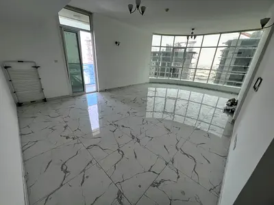 Two-bedroom apartment with a living room and a distinctive sea view in Al Rashidiya Oasis Towers, with a balcony and ample space, parking, gym, and sw