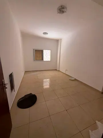 **English Advertisement** **Annual Rental – Al Jurf 2, Ajman** Spacious one-bedroom apartment with a living room, offering a comfortable layout and