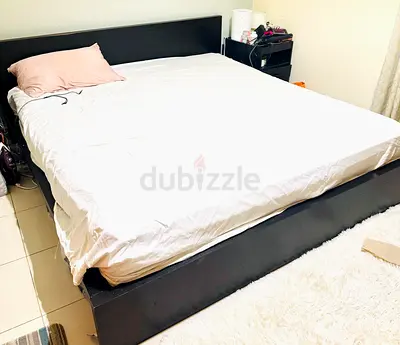 IKEA King size wooden bed frame with headboard — good condition 150 aed