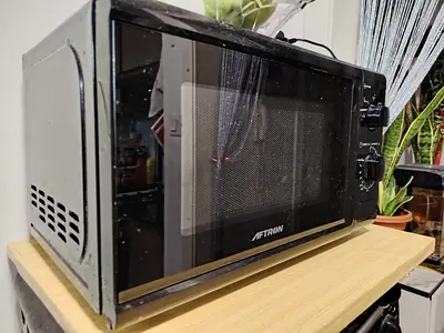 MOVING OUT SALE: Aftron countertop microwave oven