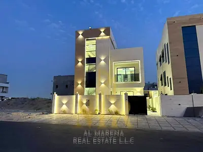 Luxury double-high villa for sale in Al Helio 2, Ajman | Land area 3,100 sq ft | Built-up area 4,000 sq ft | Two floors + roof | 5 master bedrooms | E