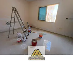 **In English:** For annual rent in Al Rashidiya 3, Ajman: Large studio, next to Amina Hospital, semi