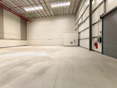 SPACIOUS INDUSTRIAL WAREHOUSE FOR RENT IN SHARJAH FEATURING HIGH CEILINGS HEAVY POWER CAPACITY EASY LOADING DOCK ACCESS AND PRIME LOCATION NEAR MAIN HIGHWAYS