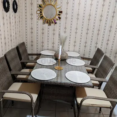 6-seater rattan dining table set with glass top and cushions