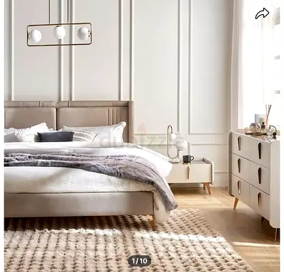 Modern upholstered bed frame with matching nightstand and dresser set.