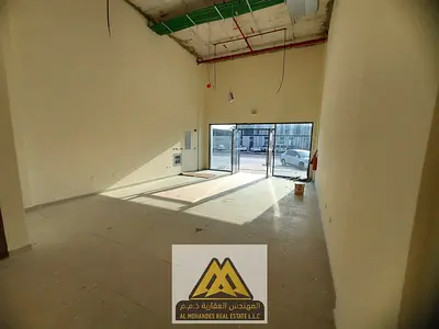 A commercial shop in Ajman Industrial Area 1, in a prime location on Omar Bin Al-Aas Street, characterized by easy access and active commercial traffi