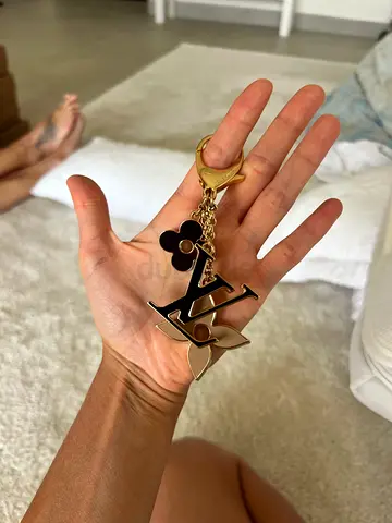 Louis Vuitton inspired gold-tone charm keychain with logo and flower charms