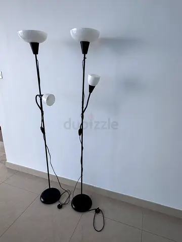 Pair of black metal floor lamps with adjustable reading lights