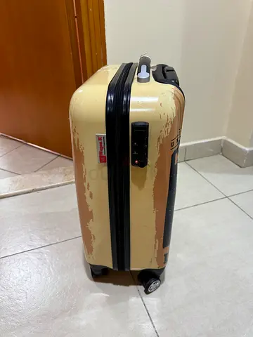 Hard-shell 2-wheel carry-on suitcase with minor exterior wear