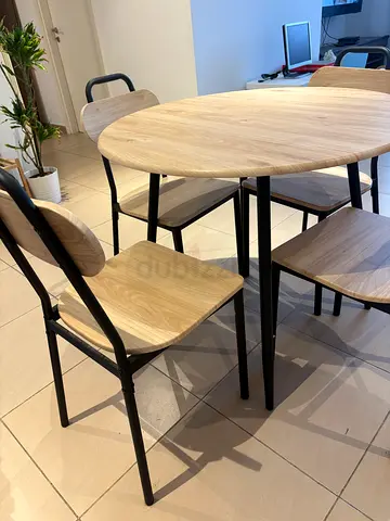 Round dining table with four chairs