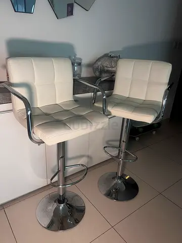 Pair of white adjustable bar stools with chrome frame