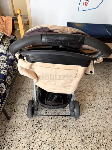 Beige baby stroller in good used condition
