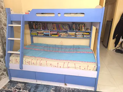 Blue bunk bed with storage drawers and ladder