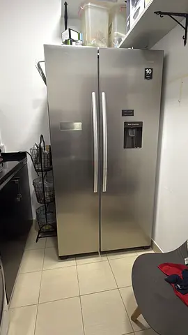 Large stainless steel side-by-side refrigerator with water dispenser