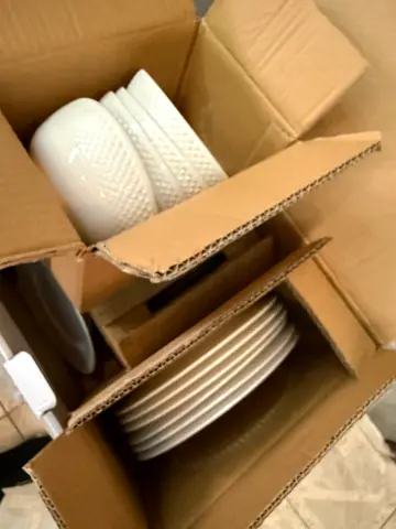 White ceramic dinnerware set — plates and bowls, unused in box