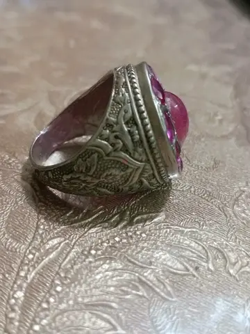 Ruby Yaqoot ring with pink cabochon stone, ornate engraved band