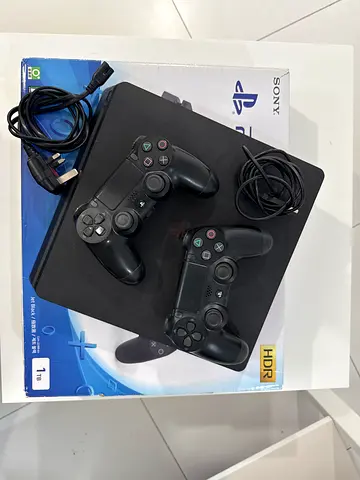 PlayStation 4 Slim 1TB with 2 Controllers and Cables - Good Condition