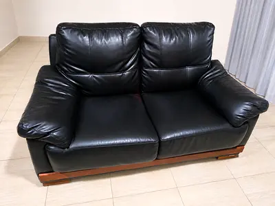 Black Leather 2-Seater Sofa with Wooden Base - Good Condition