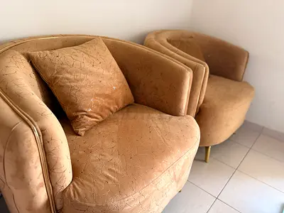 Pair of beige velvet curved armchairs — good condition